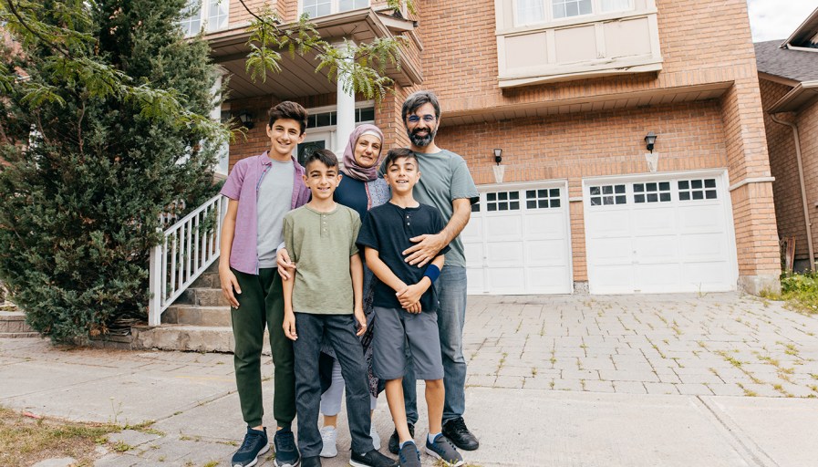 Family standing in front of home.